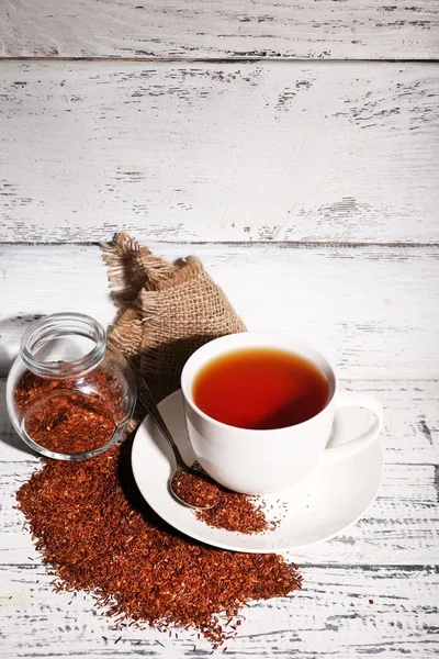 Cup of tasty rooibos tea, on old white wooden table — Stock Photo, Image