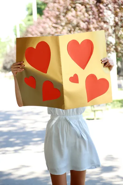 Beautiful young girl with valentines on city street — Stock Photo, Image