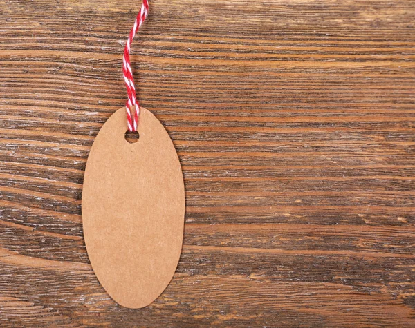 Empty tag on brown wooden background — Stock Photo, Image