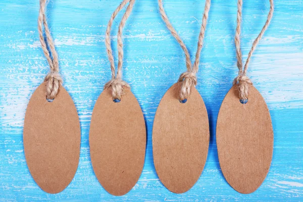 Empty tags on blue wooden background — Stock Photo, Image