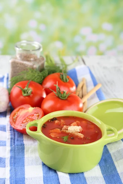 Tasty tomato soup with croutons on table on natural background — Stock Photo, Image