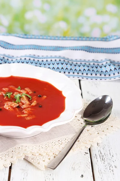 Tasty tomato soup with croutons on table on natural background — Stock Photo, Image