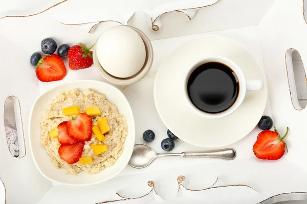 Delicious breakfast with coffee, egg and oatmeal — Stock Photo, Image