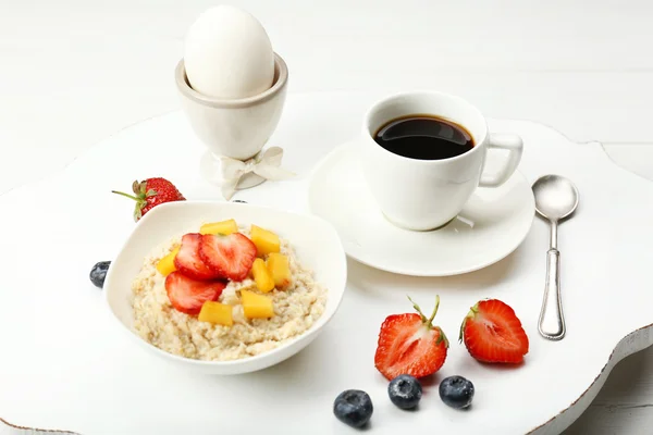 Delicious breakfast with coffee, egg and oatmeal — Stock Photo, Image