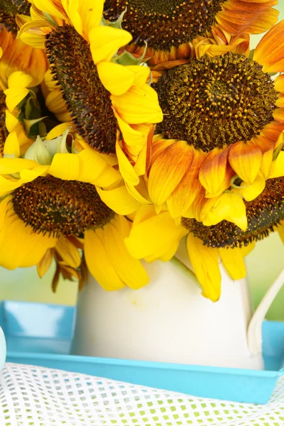 Beautiful sunflowers in pitcher on table close up — Stock Photo, Image