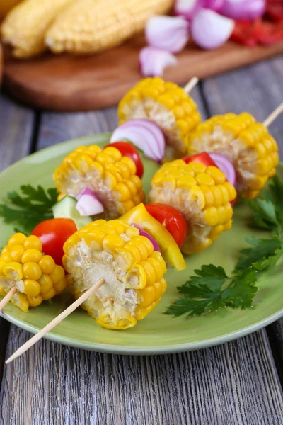 Sliced vegetables on wooden picks on plate on table close-up — Stock Photo, Image