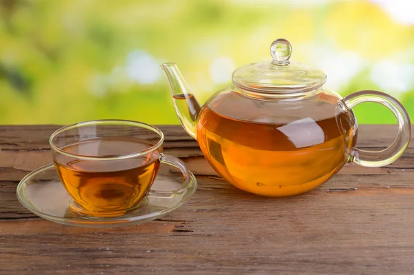 Teáskanna és a csésze tea a táblázat a világos háttér — Stock Fotó