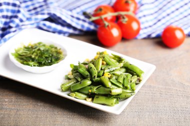 salata fasulye ve Mısır, plaka renk ahşap zemin üzerine sos ile