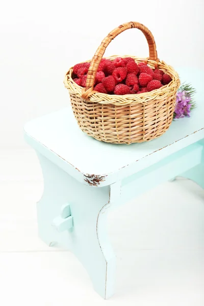 Fresh raspberries in basket on white wall background — Stock Photo, Image