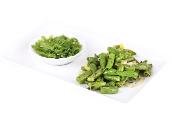 Salad with green beans and corn with sauce on plate, isolated on white — Stock Photo, Image