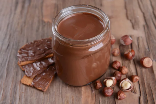 Sweet chocolate cream in jar on table close-up — Stok Foto