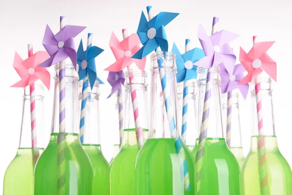 Bottles of drink with straw isolated on white — Stock Photo, Image