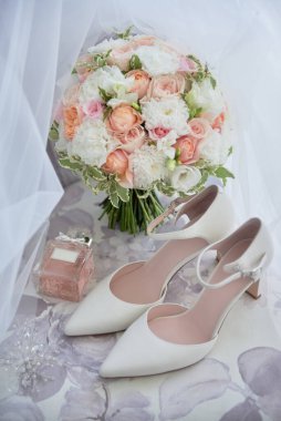 Gelin buketi, gelin ayakkabıları, sandalyede küpeler, fotokopi odası. Lüks düğün aksesuarları ve mücevherleri. Düğün konsepti 