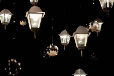 Yeşil arka planda lüks düğün dekorasyonları, fotokopi alanı. Bahçedeki büyük ağaçta fenerler ve çelenkler