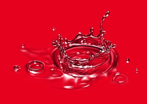 Wasserspritzer isoliert auf Rot — Stockfoto