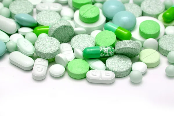 Tablets and capsules on white background — Stock Photo, Image
