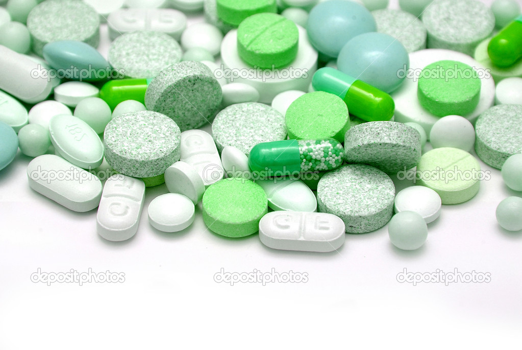 Tablets and capsules on white background