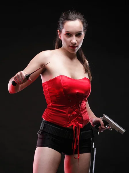 Sexy young woman - gun on black background — Stock Photo, Image