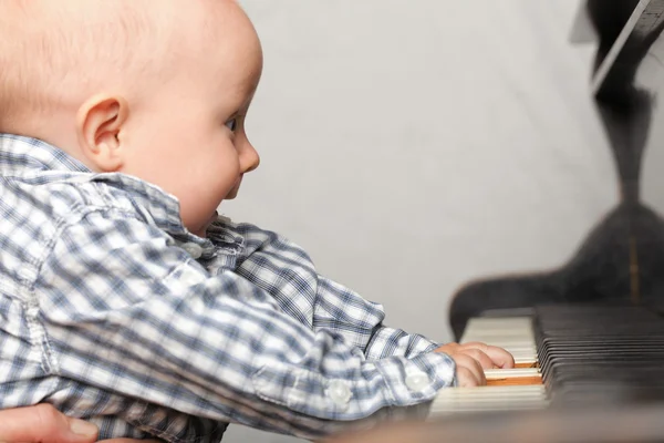 Beau petit garçon joue du piano — Photo