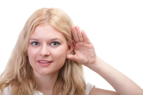 Woman eavesdropping with hand behind her ear — Stock fotografie