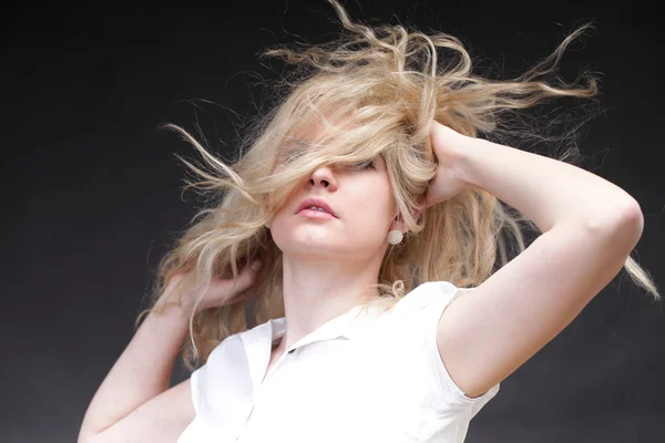 Blonde woman with her hair blowing — Stock Photo, Image