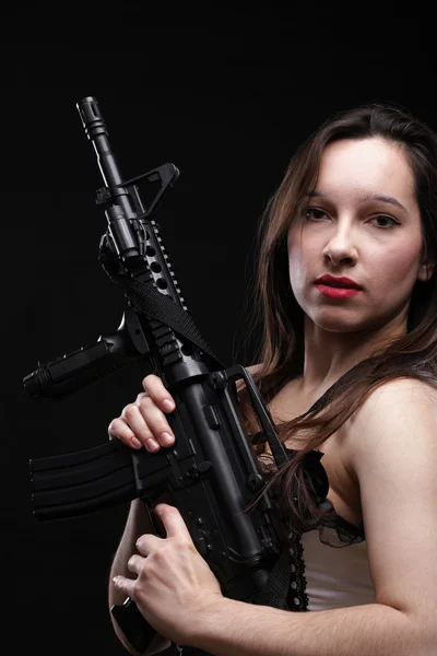 Girl holding Rifle on black background — Stock Photo, Image