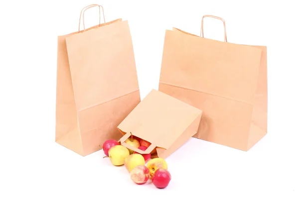 Shopping brown gift bags and apple isolated — Stock Photo, Image