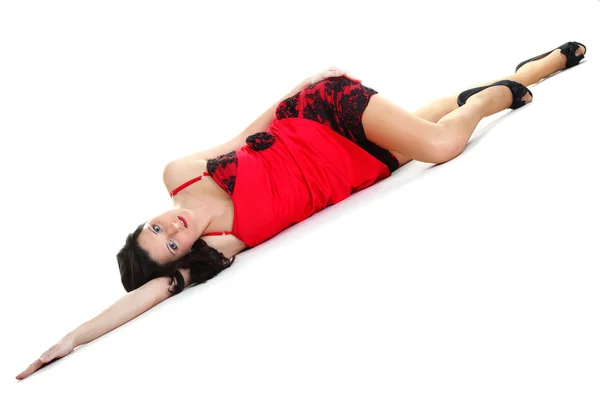 Woman laying on floor studio isolated — Stock Photo, Image