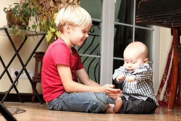 Little boy playing with a brother — Stock Photo, Image
