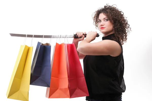 Lovely woman with shopping bags and sword — Stock Photo, Image