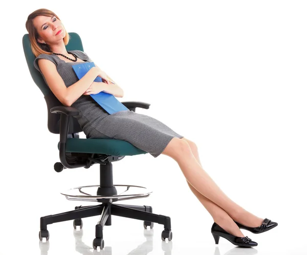 Full length business woman sitting on chair holding clipboard is — Stock Photo, Image