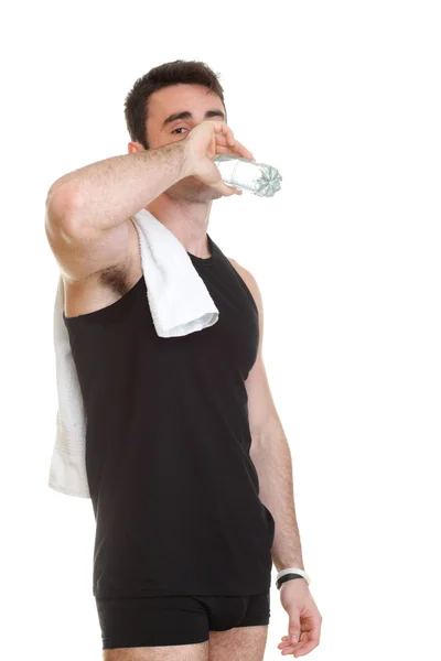Smiling young man holding towel bottle water isolated background — Stock Photo, Image