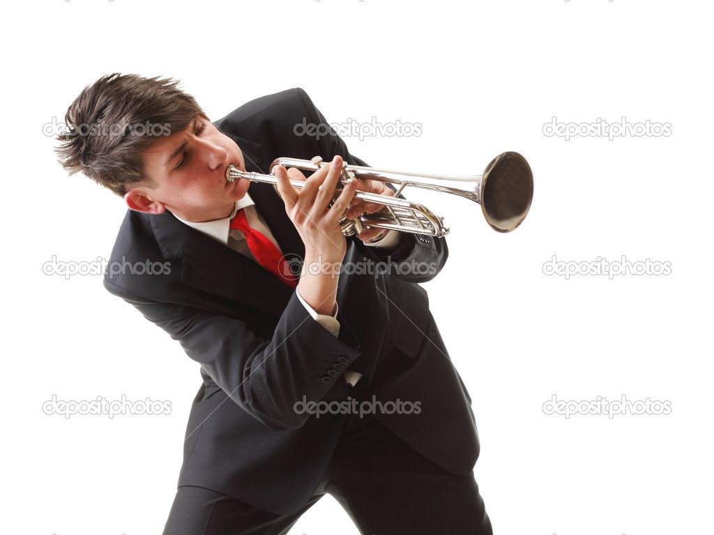 Portrait of a young man playing his Trumpet plays isolated white