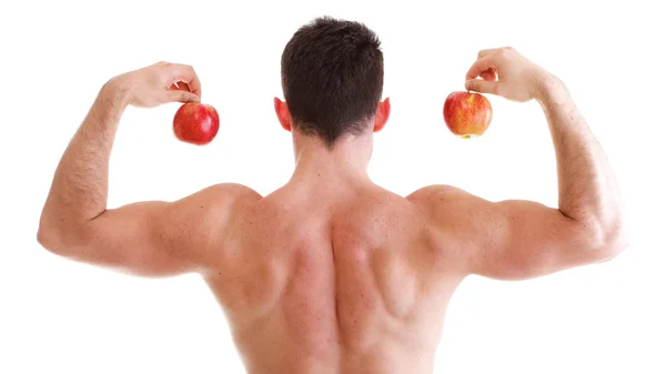 Sportovní sexy mužské tělo tvůrce drží červené jablko — Stock fotografie