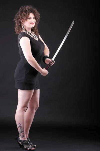 Curly woman curly girl and sword — ストック写真