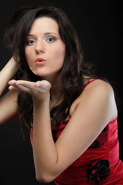 Portrait of a cute young female blowing a kiss towards — Stock Photo, Image