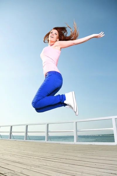 Attractive girl Young woman jumping sky — Stock Photo, Image
