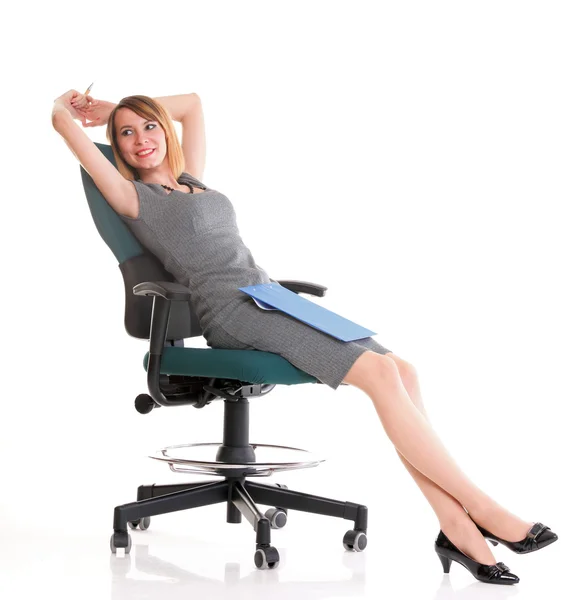 Full length business woman sitting on chair holding clipboard is Royalty Free Stock Photos