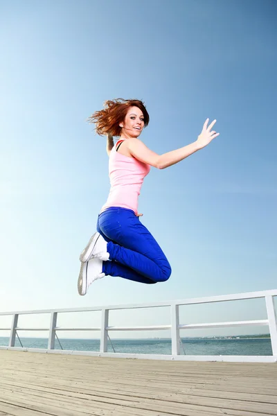 Attractive girl Young woman jumping sky — Stock Photo, Image