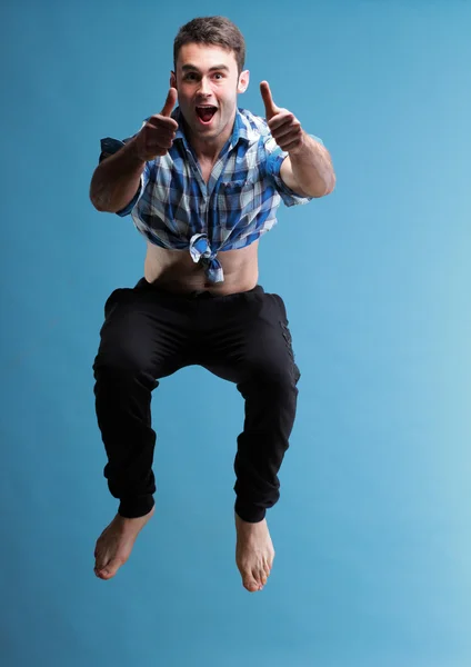 Young man jumping isolated gray background — Stock Photo, Image