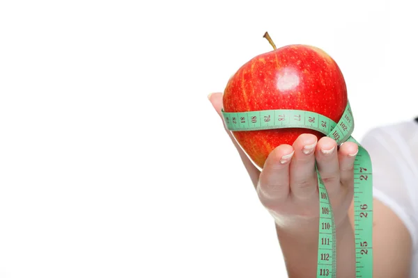 Woman hand with red apple and measure tape isolated Royalty Free Stock Photos