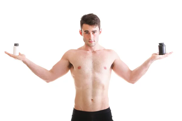 Holding a boxes with supplements on his biceps — Stock Photo, Image