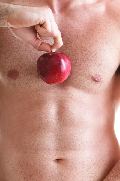 Muscle naked young man torso red apple in hands — Stock Photo, Image