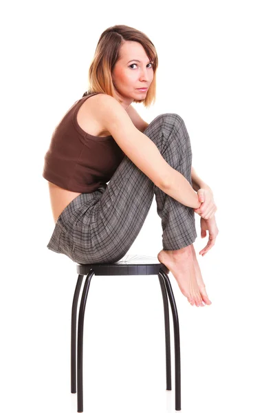 Worried and afraid young woman sitting on chair. Isolated — Stock Photo, Image