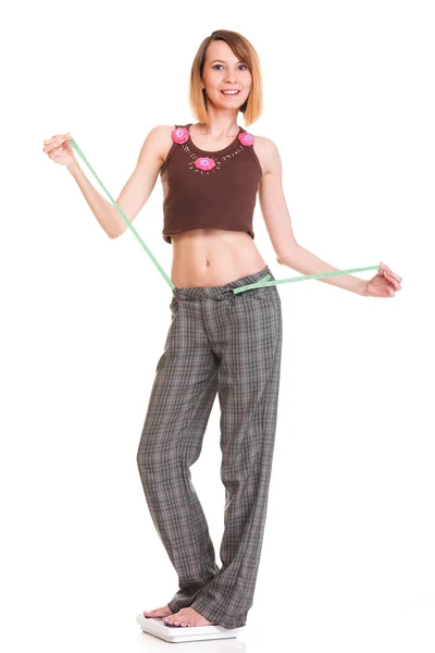 Pretty woman shows her weight loss wearing measure tapes isolate — Stock Photo, Image