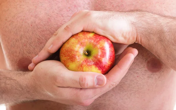 Muscle naked young man torso red apple in hands — Stock Photo, Image