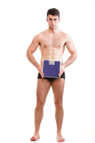 Healthy young man with a weight scale Isolated — Stock Photo, Image