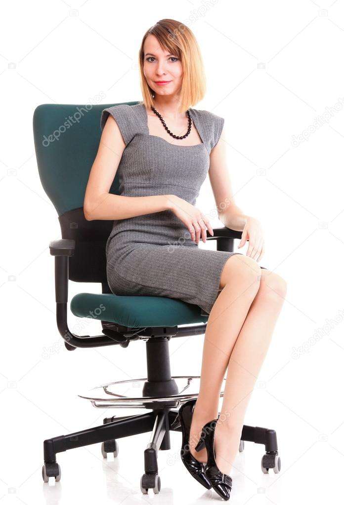 Full length business woman sitting on chair holding clipboard