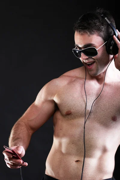 Handsome man listening to music on headphone — Stock Photo, Image