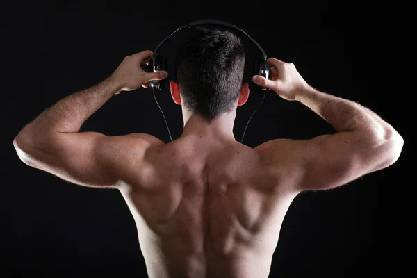 Handsome man listening to music on headphone — Stock Photo, Image